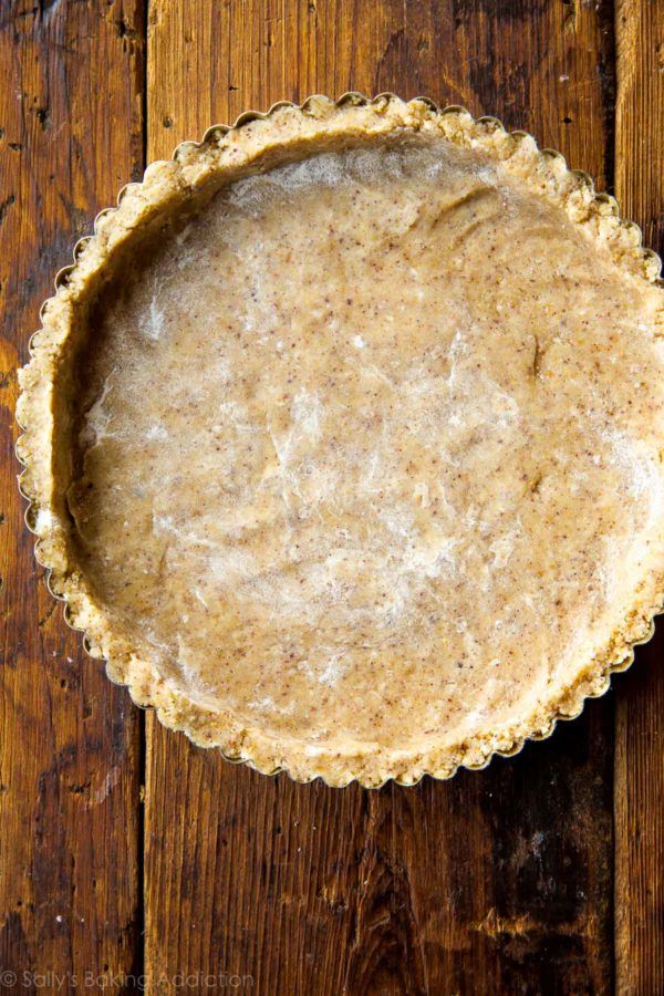 an uncooked pie crust sitting on top of a wooden table