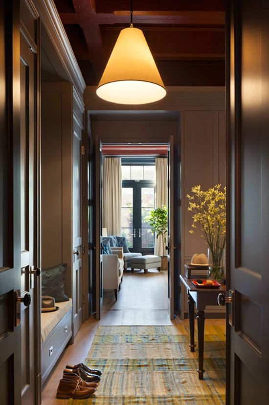 the hallway is decorated in wood and has a rug on the floor, along with shoes