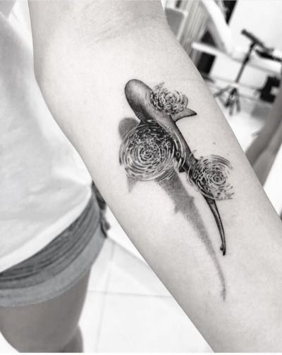 a black and white photo of a tattoo on the arm