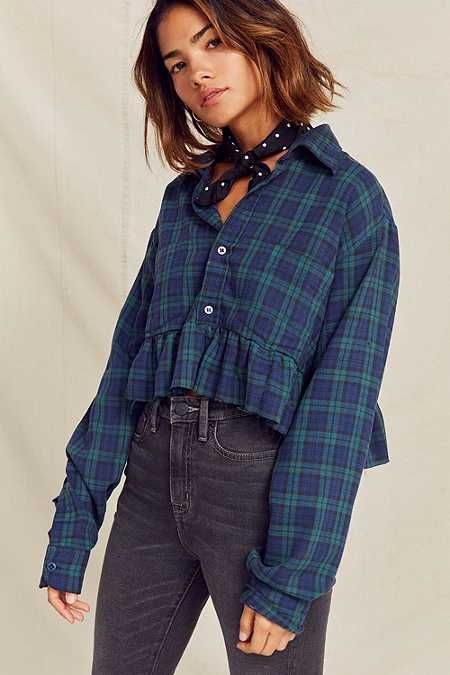 an image of a woman wearing a blue and green plaid shirt with ruffles