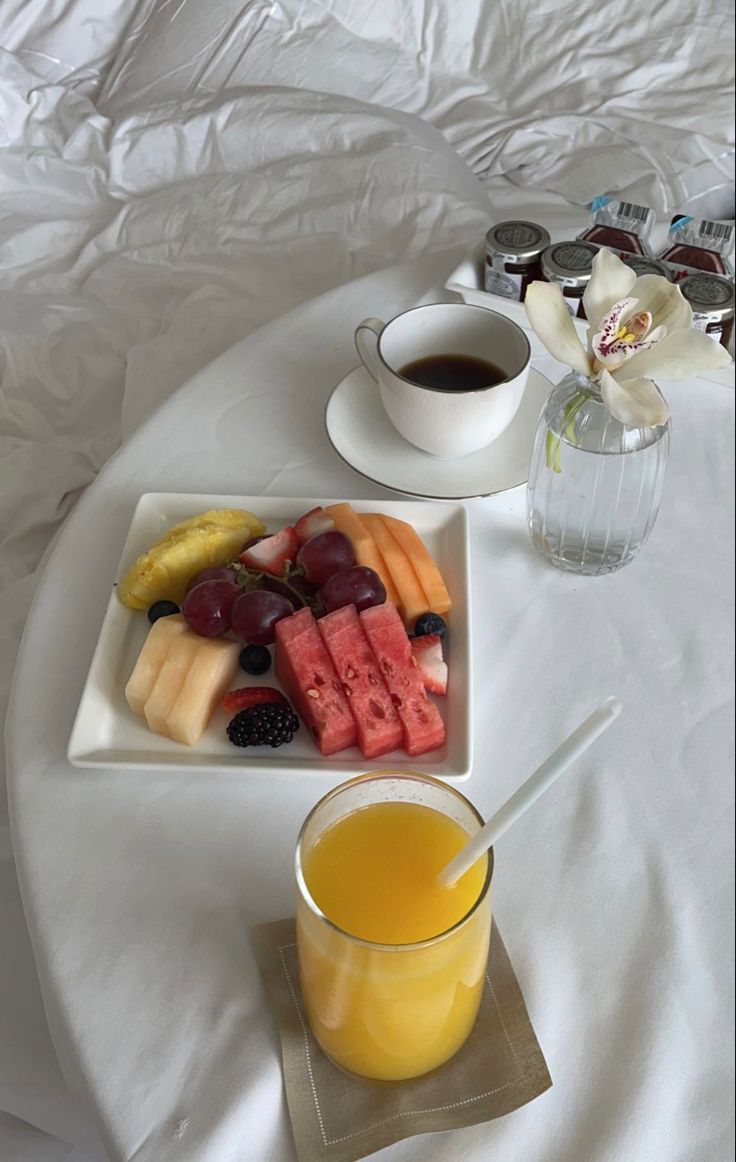 there is a tray with fruit and juice on it