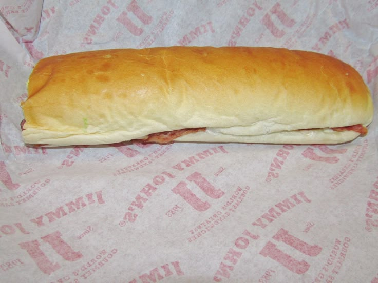 a sub sandwich sitting on top of a wrapper