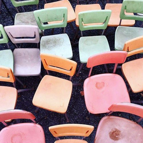 many different colored chairs sitting next to each other