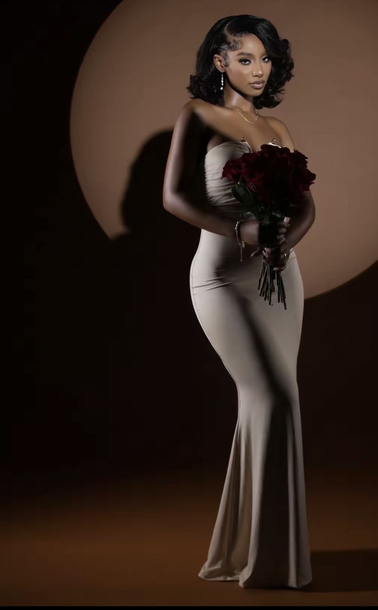 a woman in a white dress holding flowers