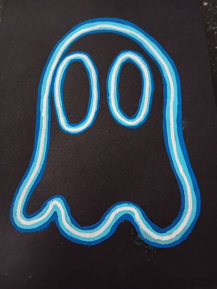 a black and blue sticker with a ghost on it's face in the shape of a letter o