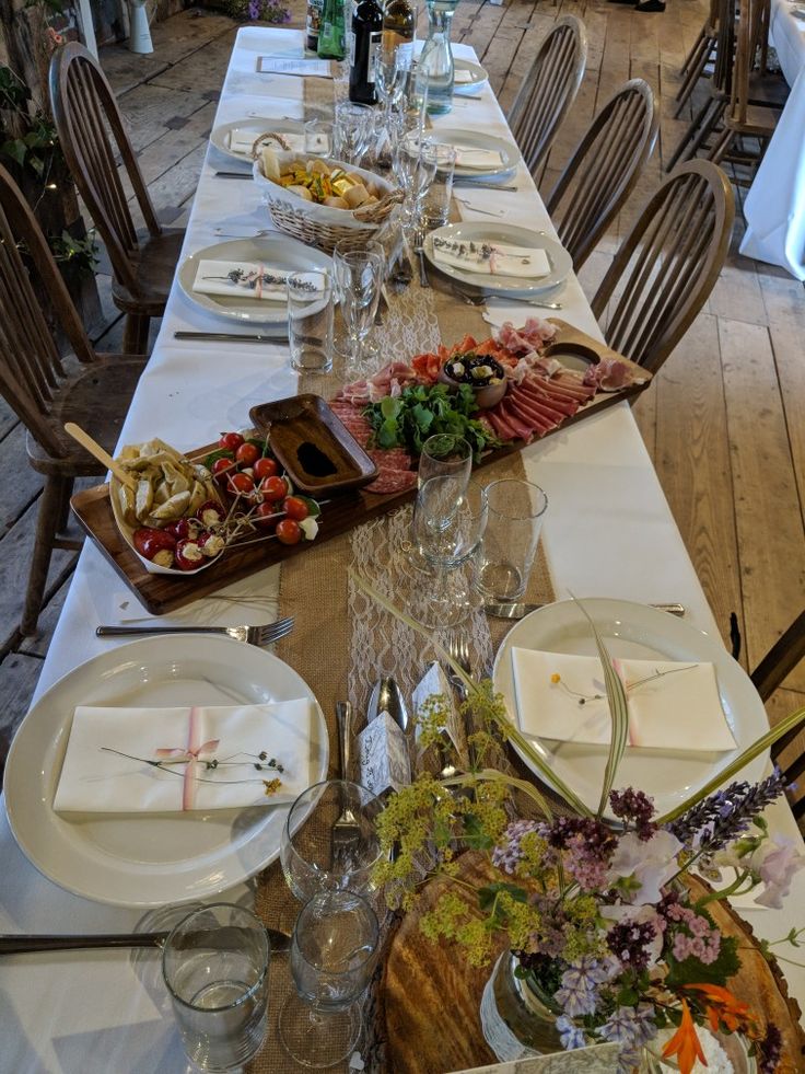 a long table is set with plates and silverware