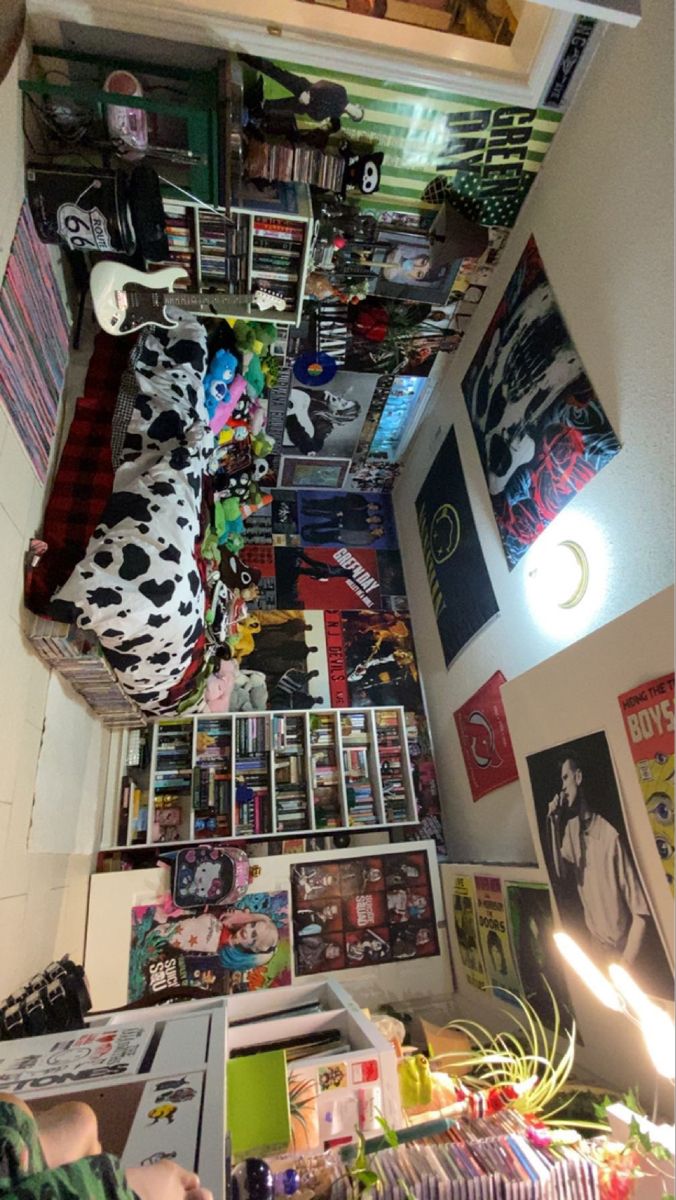 an overhead view of a room with posters and pictures on the wall, including a bed