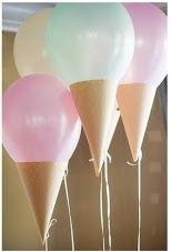 three ice cream cones with balloons attached to them