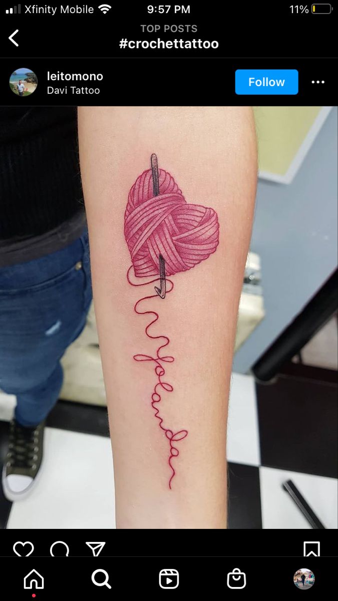 a tattoo on the leg of a woman with a pink ball of yarn in it