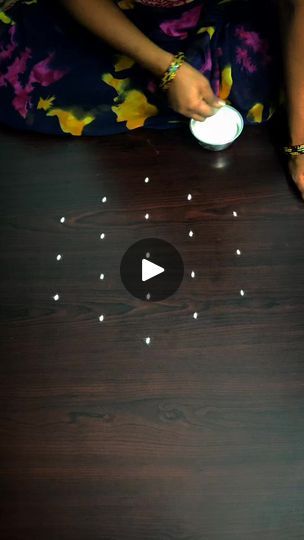 a woman is sitting at a table with white lights on it