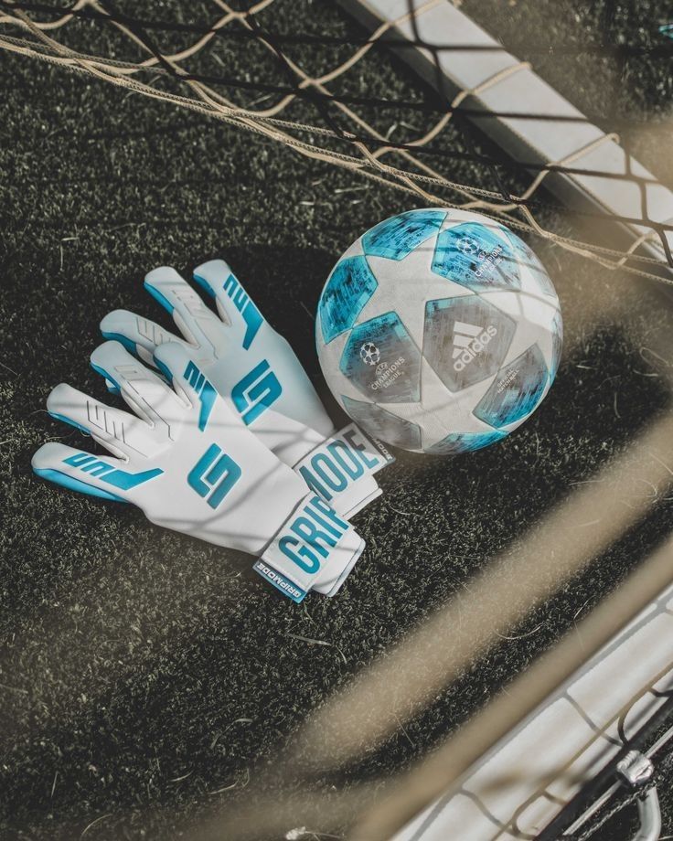 a soccer ball and glove laying on the ground