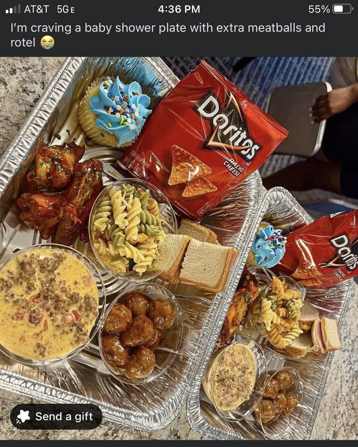 a tray filled with lots of food on top of a counter next to a bag of chips