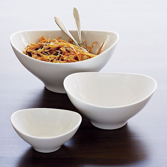 three bowls with spoons in them sitting on a table