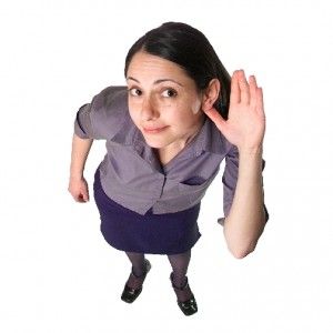 a woman with her hands up in the air and looking at something on her head