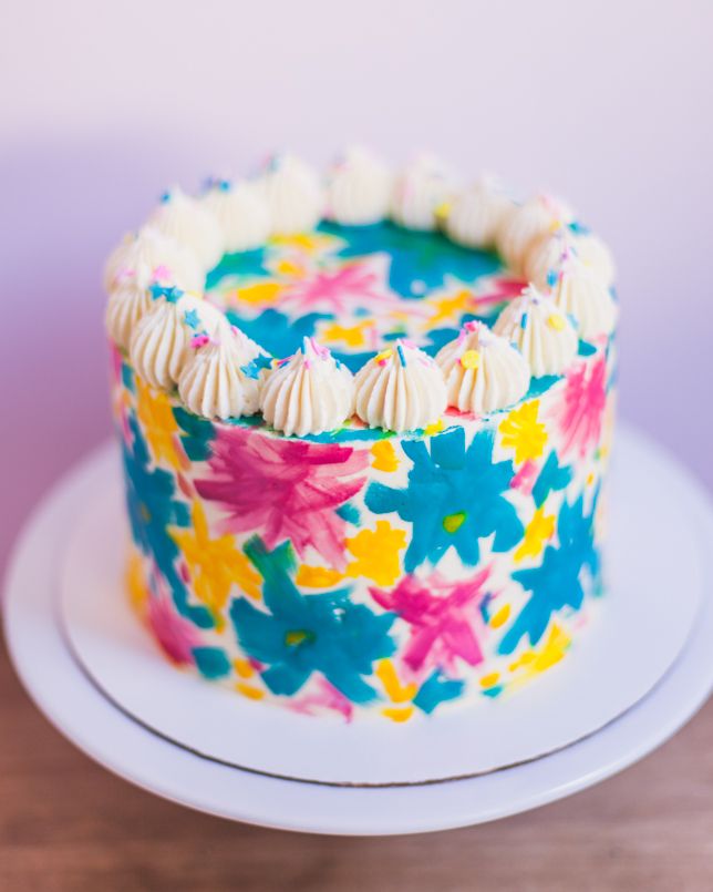 a colorful cake sitting on top of a white plate