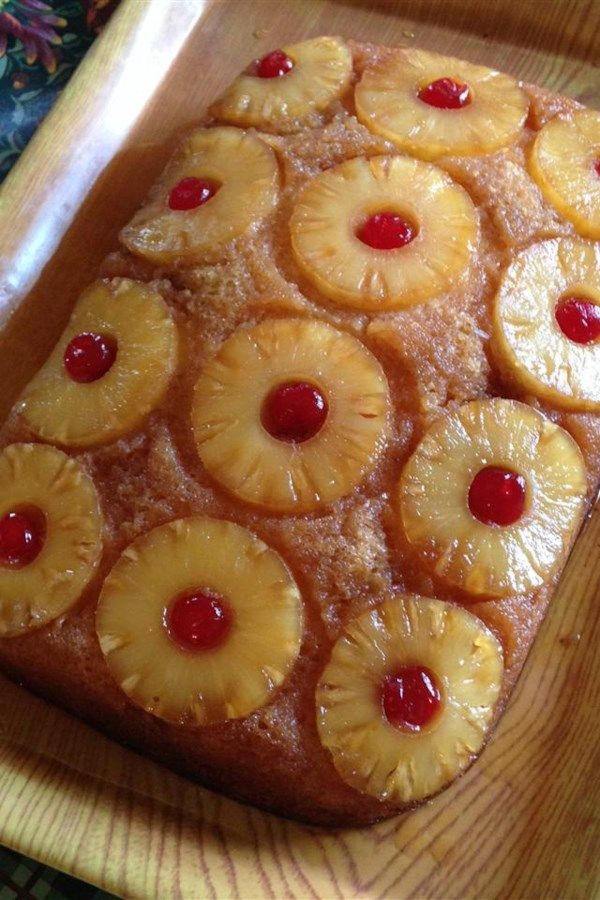 pineapple upside down cake sitting on top of a wooden table