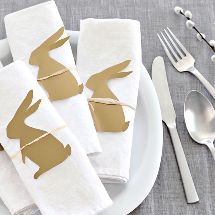 napkins decorated with gold bunny ears on a white plate