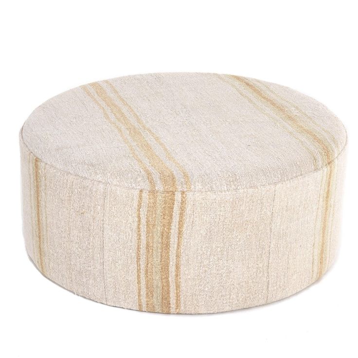 a round ottoman that has stripes on it