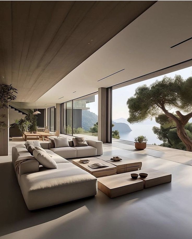 a living room with large windows overlooking the water