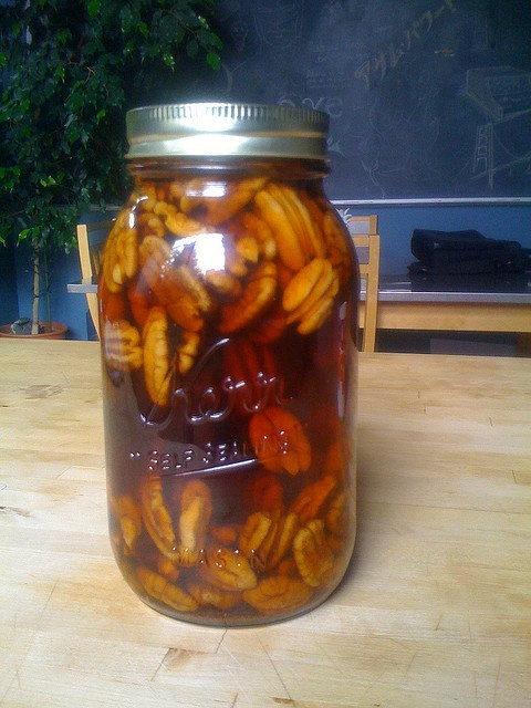 a jar filled with bananas sitting on top of a wooden table