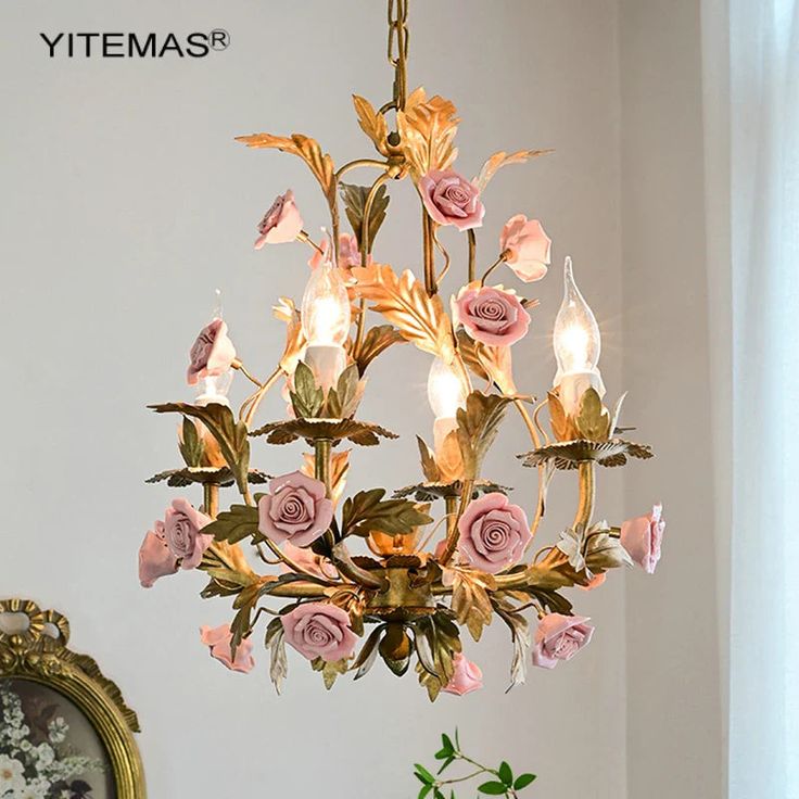 a chandelier with pink roses hanging from it