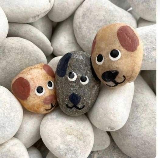 three rocks with faces painted on them