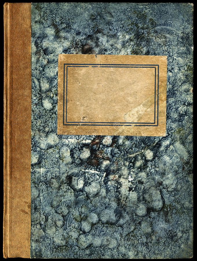 an old book with a blank page on the cover and some rocks in the background