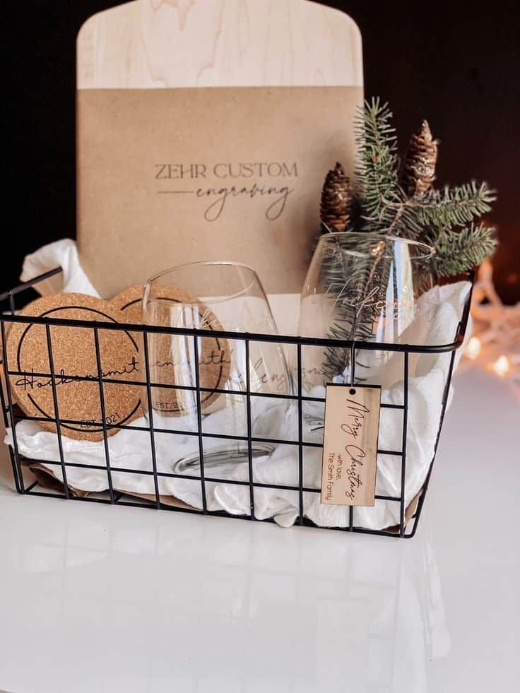 a basket filled with cookies and wine glasses next to a card holder on a table