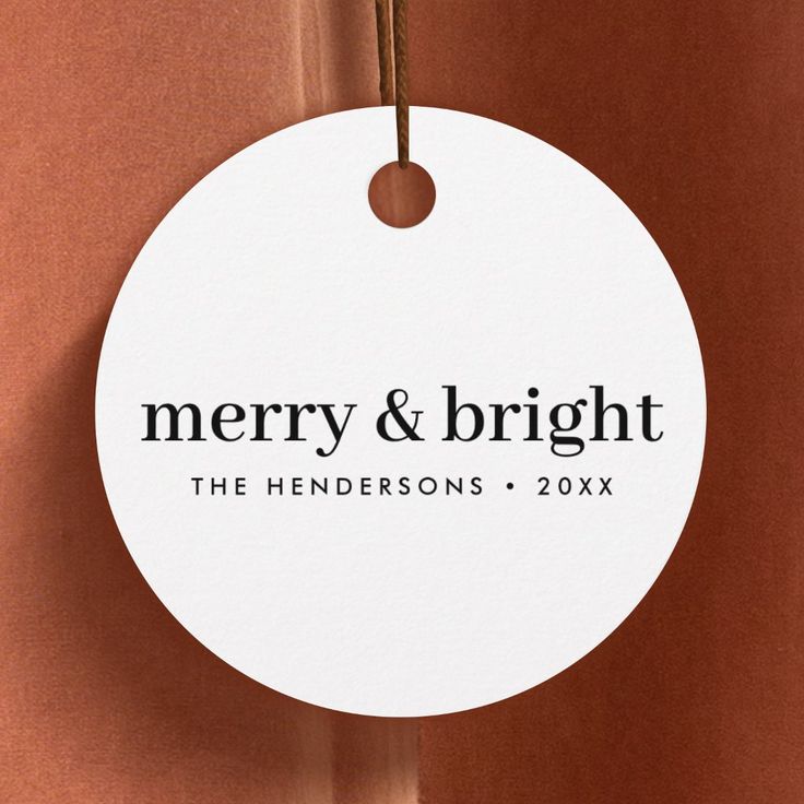 merry and bright round ornament hanging on a wall with string attached to it