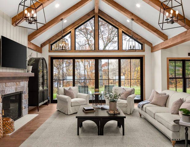 a large living room with high ceilings and wooden beams