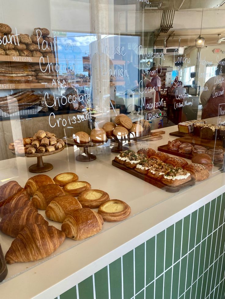 breads and pastries on display in a bakery window