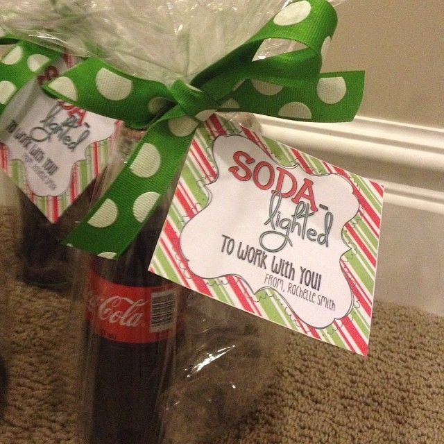 two soda bottles wrapped in green and white polka dot paper, tied with a green ribbon