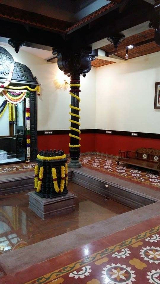 an elaborately decorated room with a bench and mirror