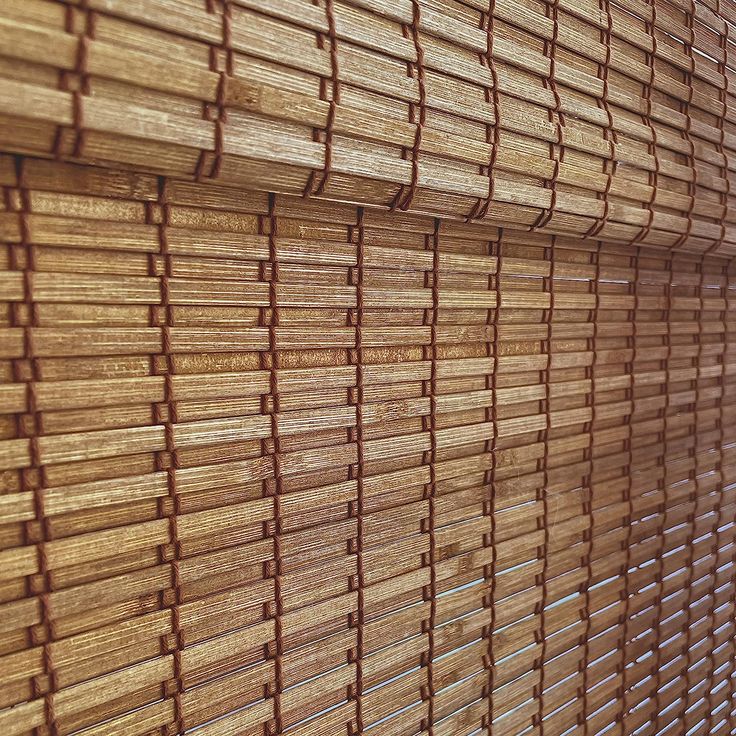 bamboo blinds are lined up against the wall