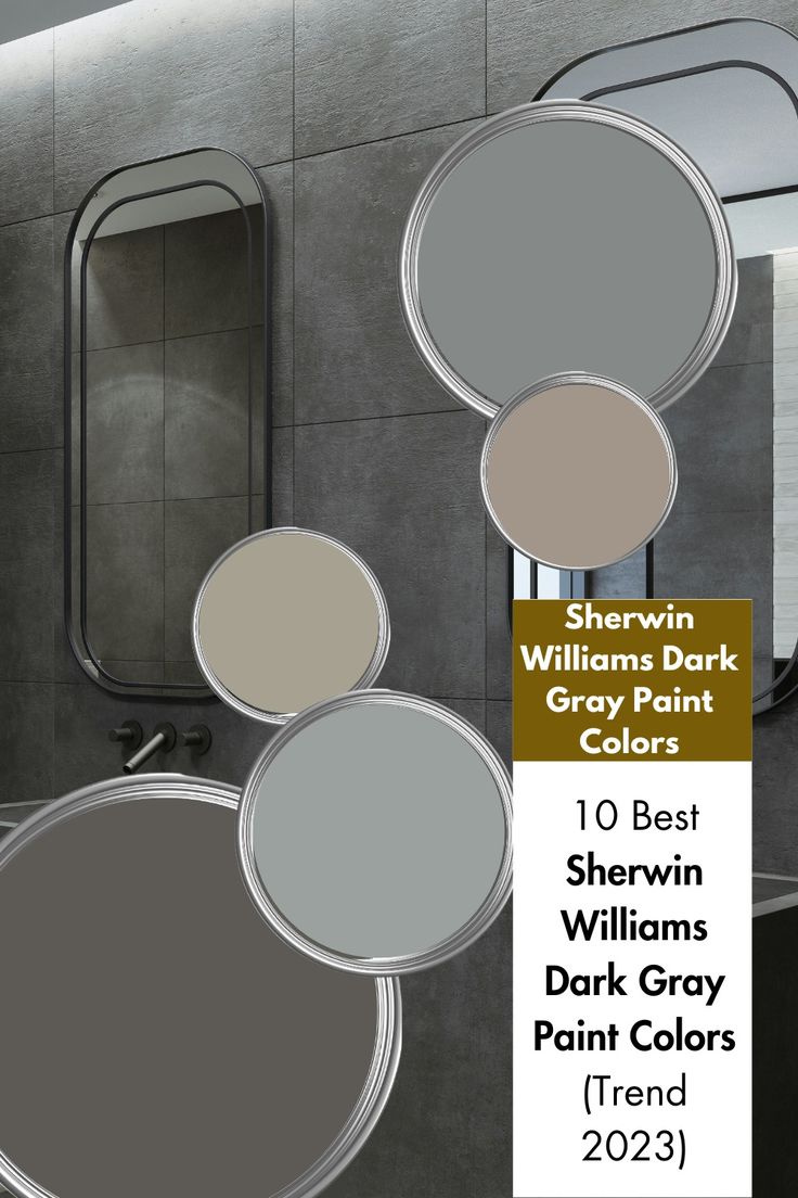 a bathroom with gray walls and mirrors