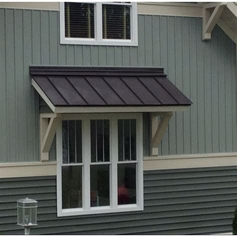 a dog is looking out the window of a house with an awning on it's roof