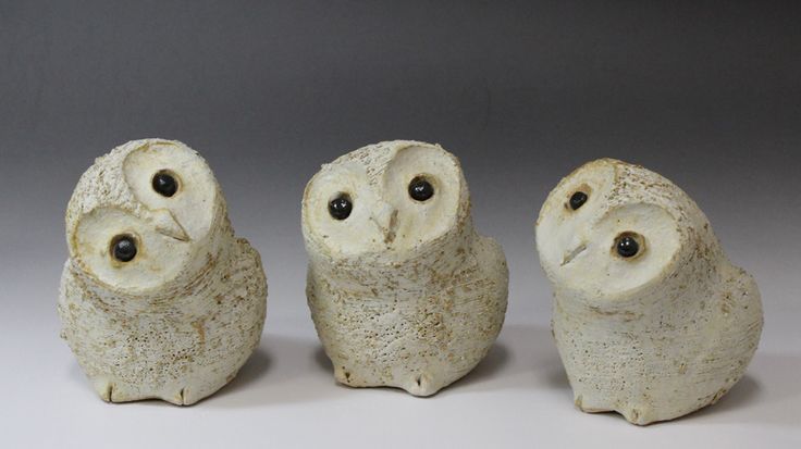 three ceramic owls sitting next to each other