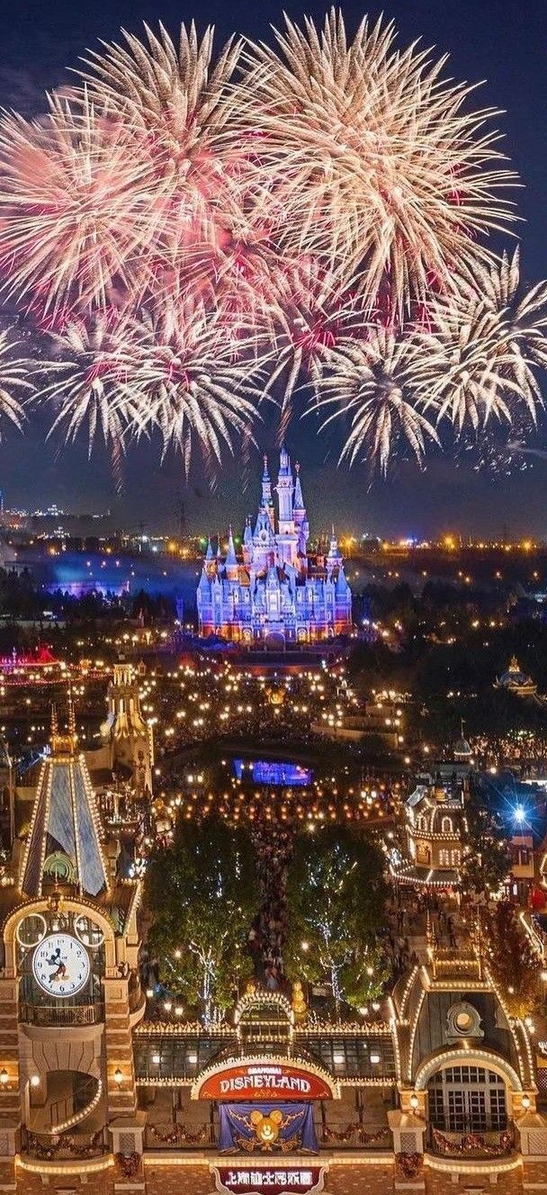 fireworks are lit up in the sky above disney's castle