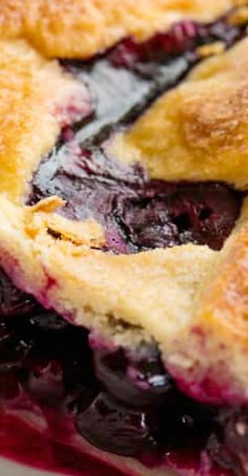 a close up of a blueberry pie on a plate