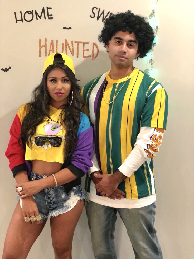 a man and woman dressed in costumes standing next to each other