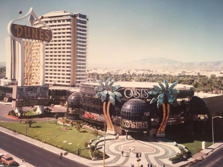 an aerial view of the outside of a casino with palm trees and buildings in the background