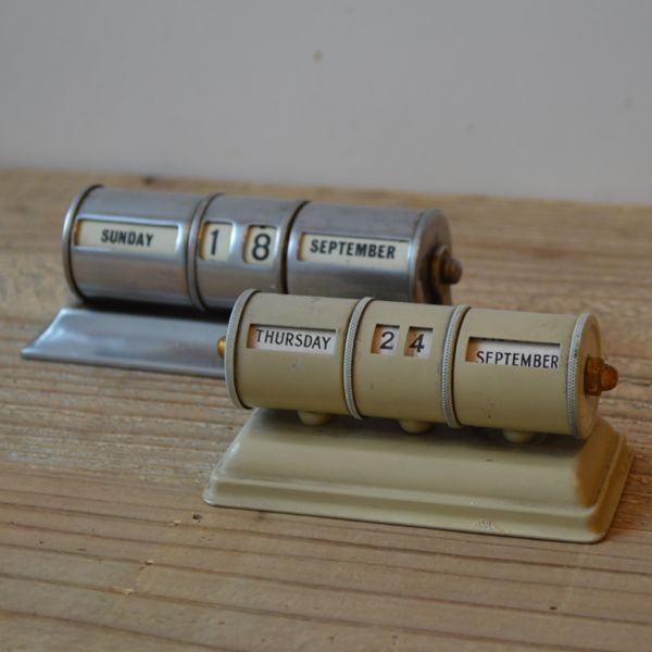 two silver batteries sitting on top of a wooden table next to each other with the numbers thirteen, twenty and seven