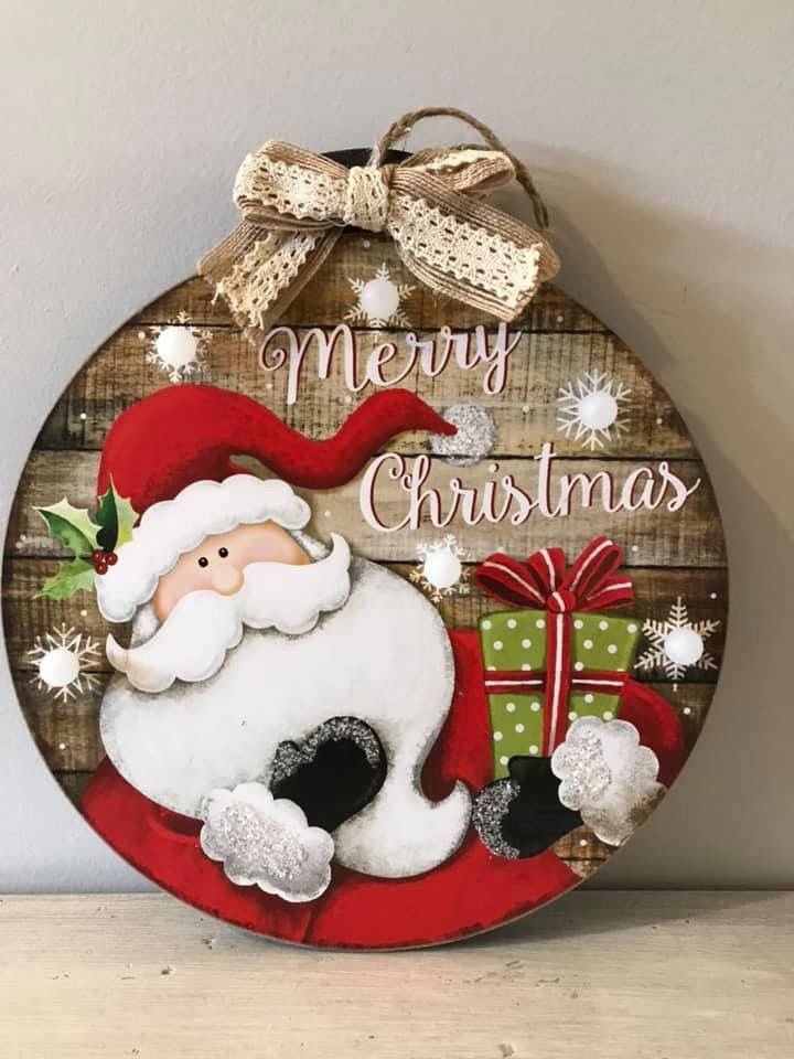 a wooden sign with a santa clause on it