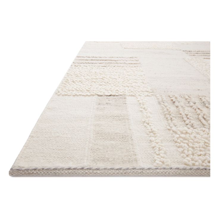 a white rug with different colored squares on it