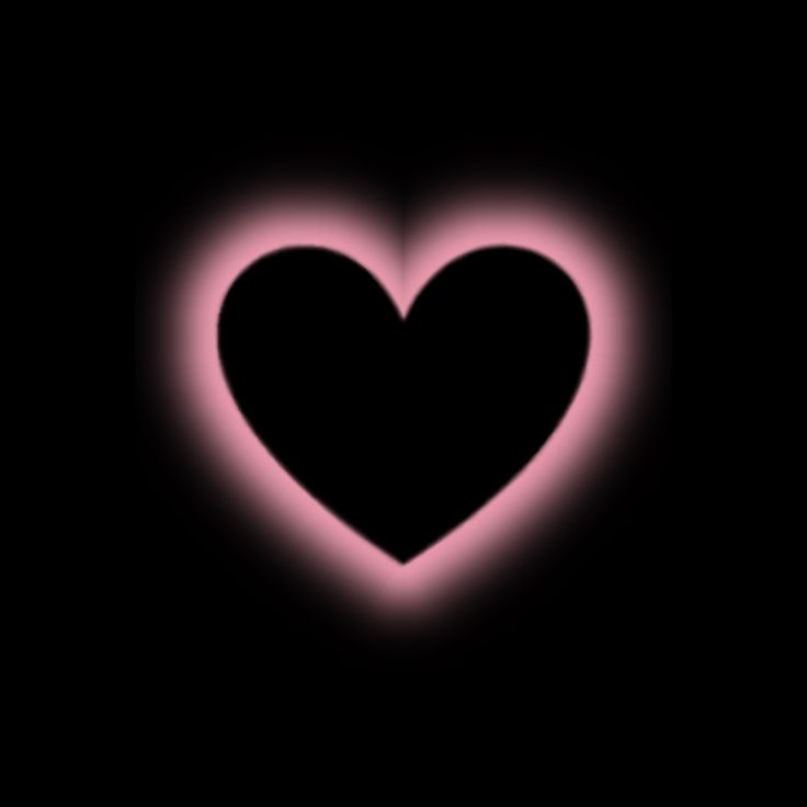 a heart shaped object in the dark with pink light coming from it's center