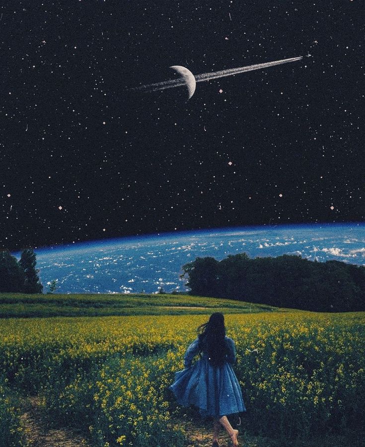 a woman is walking through a field at night with the moon in the sky above her