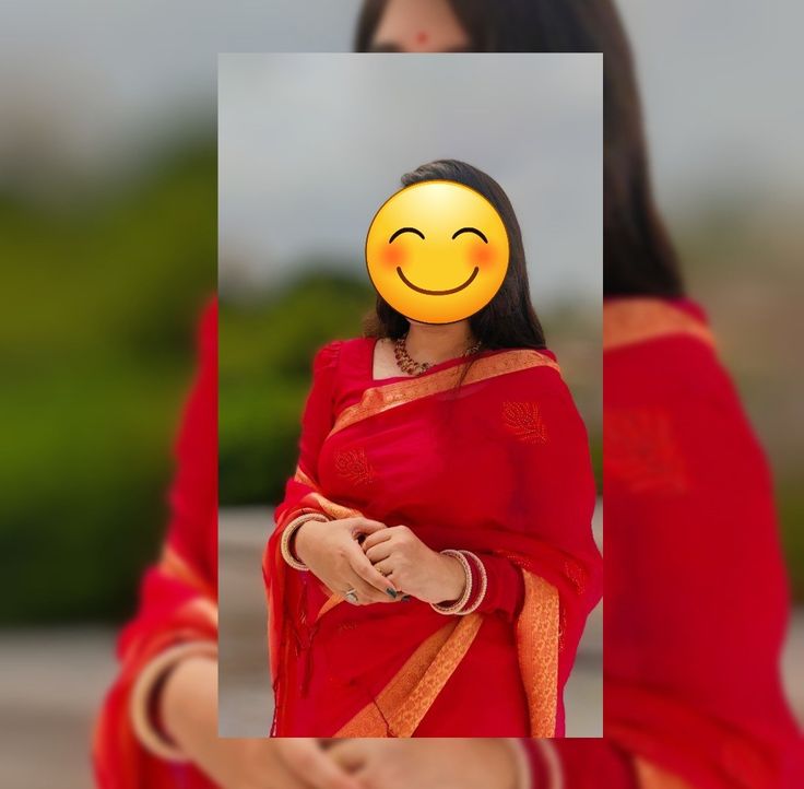 a woman wearing a red sari with a yellow smiley face on it's head