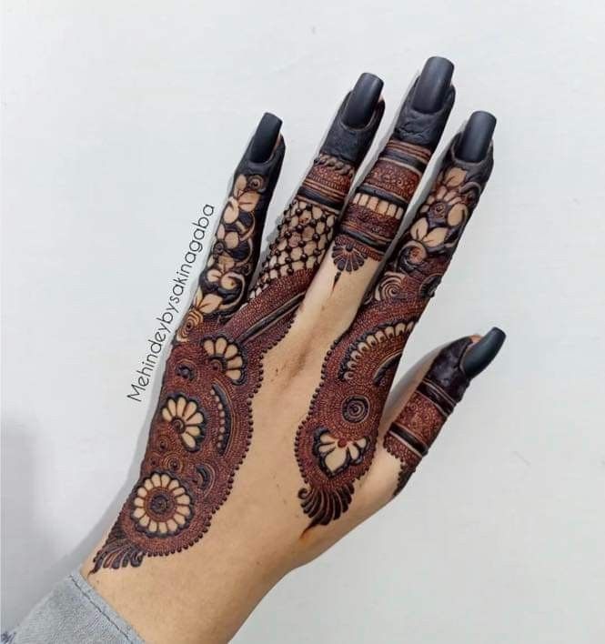 the hand is decorated with henna designs on it