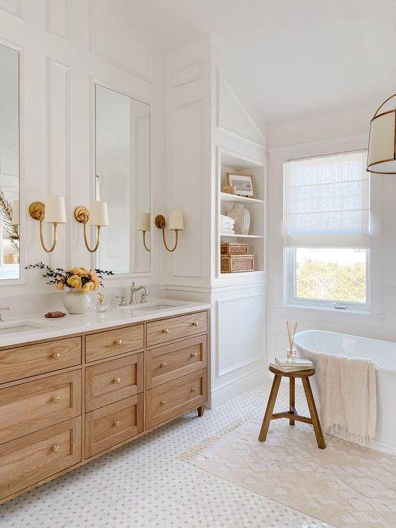 a white bathroom with two sinks and a tub