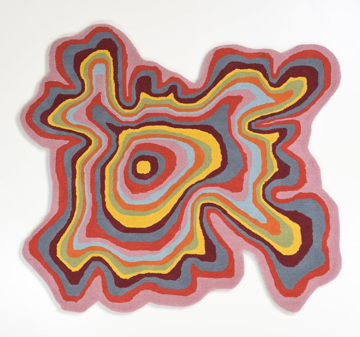 an abstract rug with multicolored shapes on white background in the shape of a flower